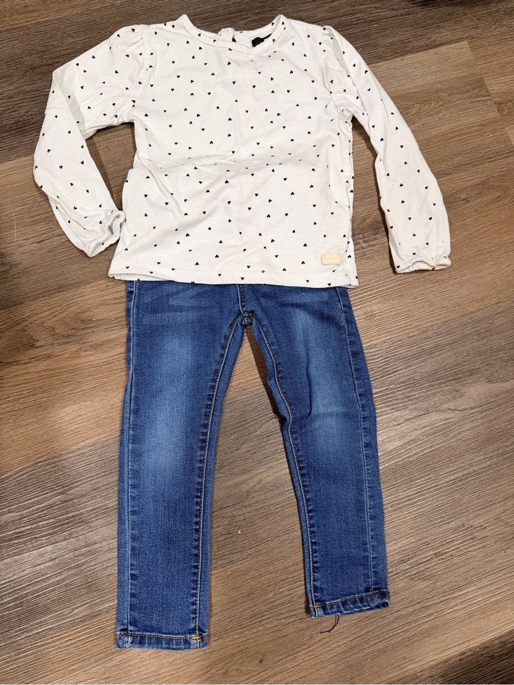 7 For All Mankind Jeans and White Long-Sleeve Top with Black Heart Print